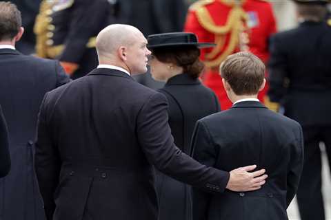 Touching moment Queen’s youngest grandson James, 14, is comforted by cousin-in-law Mike Tindall at..